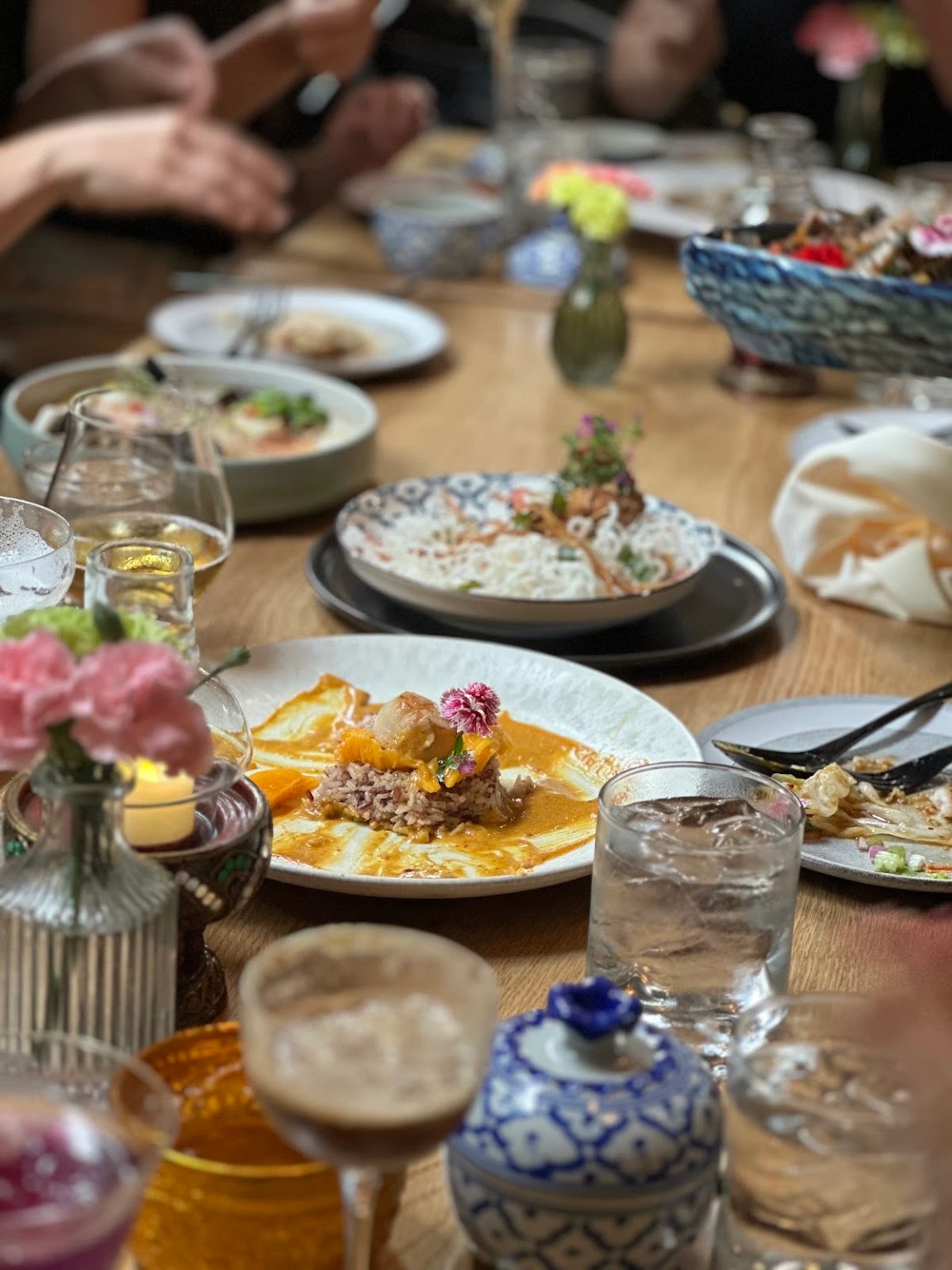 Shared restaurant table with dishes and drinks